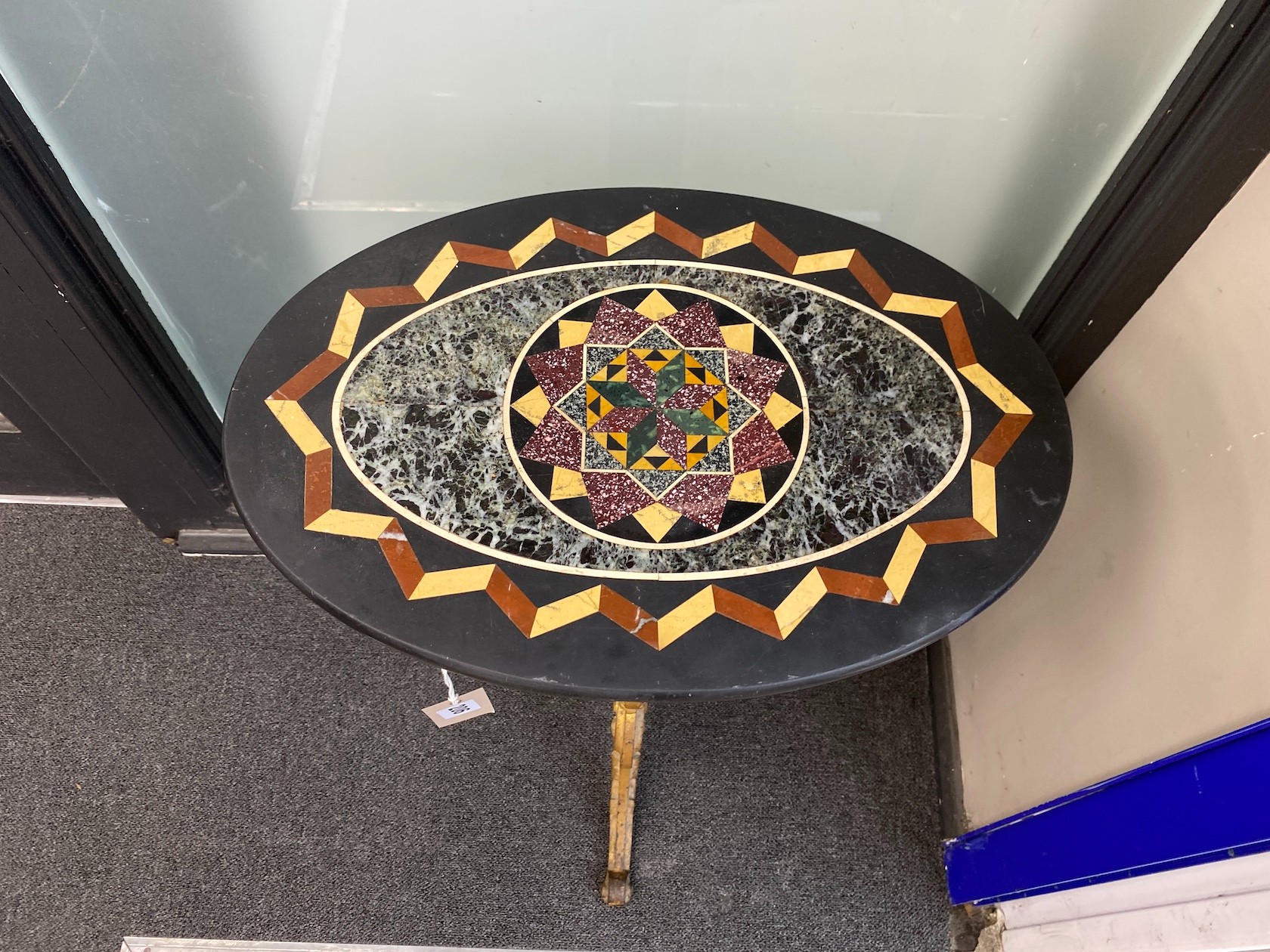 A Victorian cast iron table with oval specimen marble top, width 48cm, depth 33cm, height 72cm